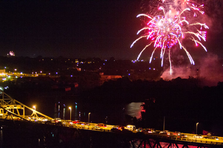 Fireworks being shot over the Tennessee River above O'Neal Bridge.