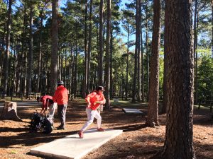 A man throwing a disc at the disc golf course at McFarland Park in Florence, Alabama.